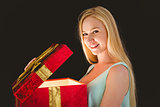 Festive blonde opening a gift
