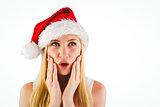 Festive blonde looking surprised with hands on face
