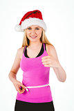 Fit festive young blonde measuring her waist