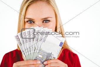 Pretty blonde in red dress showing her cash