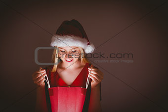 Festive blonde opening a gift bag