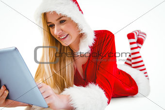 Festive blonde using tablet pc