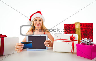 Festive blonde shopping online with tablet pc