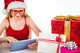 Festive blonde shopping online with tablet pc