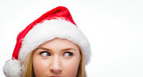 Festive blonde looking across in santa hat