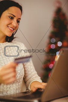Pretty brunette shopping online at christmas
