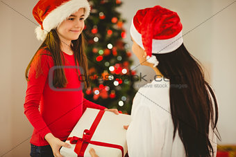 Daughter giving her mother a christmas present