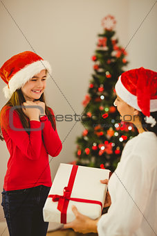 Mother giving her daughter a christmas present