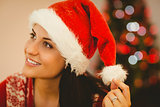 Festive brunette wearing a santa hat