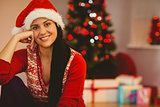 Festive brunette wearing a santa hat