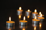 Eight small candles burning