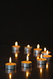 Eight small candles burning