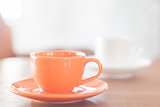 Mini orange coffee cup and white coffee cup