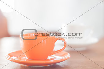 Mini orange coffee cup and white coffee cup