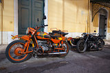 Two historic motorcycle with sidecar on a street