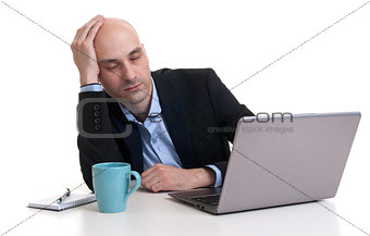 Tired businessman sleeping on a laptop