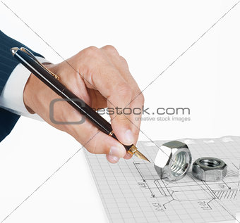hand with penl drawing construction plan