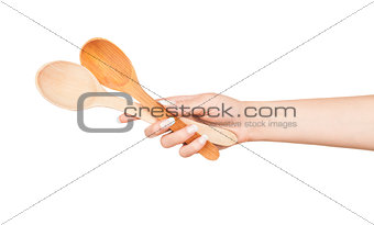 Woman hand with wooden spoon isolated on white background