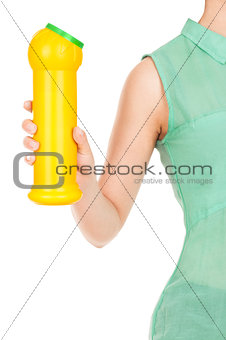 Hand holds detergent bottle. Isolated on a white background.