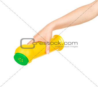 Hand holds detergent bottle. Isolated on a white background.
