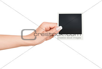 Hand holding blank Instant Photo on white background