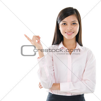 Asian business woman pointing on copy space 