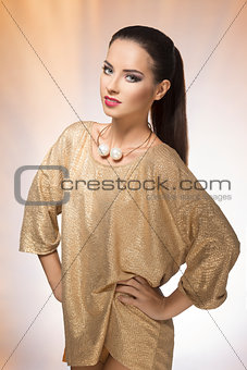 Young woman in spakling gold dress