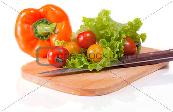 Fresh vegetables on a chopping board and knife