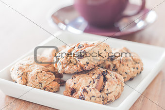 Closeup mixed nut cookies with violet coffee cup