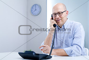 serene office worker on the telephone