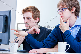 young men working together in an office