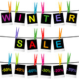 Winter sale concept with photo frames hanging on clothespins