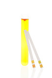 Urine in test tube and pH test strips.