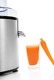 Juicer and fresh carrot juice isolated.