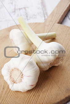 Garlic on wooden kitchen board.