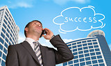 Businessman talking on the phone. Cloud with word success