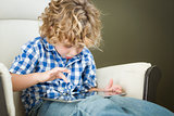 Young Blond Boy Using His Computer Tablet