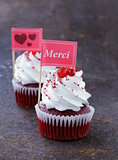 festive red velvet cupcakes with a gift compliment card