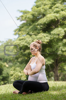 pregnant woman mother belly relaxing park yoga prayer