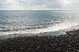 Black pebbles and sea
