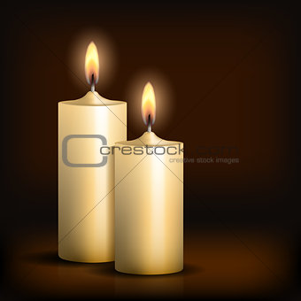Two burning candles on black background.