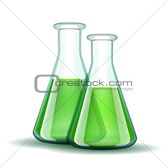 Chemical laboratory transparent flasks with green liquid.