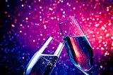 champagne flutes with gold bubbles on blue tint light bokeh background