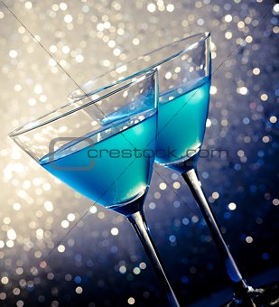 two glasses of blue cocktail on table