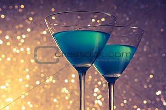glasses of blue cocktail on table