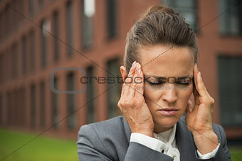 Portrait of stressed business woman in front of office building