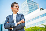 Portrait of confident business woman in front of office building