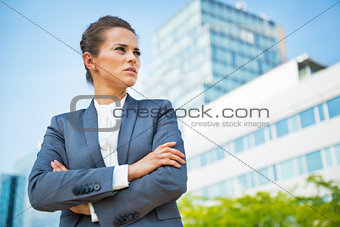 Portrait of confident business woman in front of office building