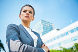 Portrait of serious business woman in front of office building
