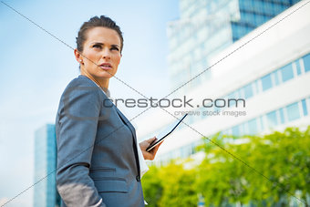 Portrait of confident business woman with tablet pc in office di